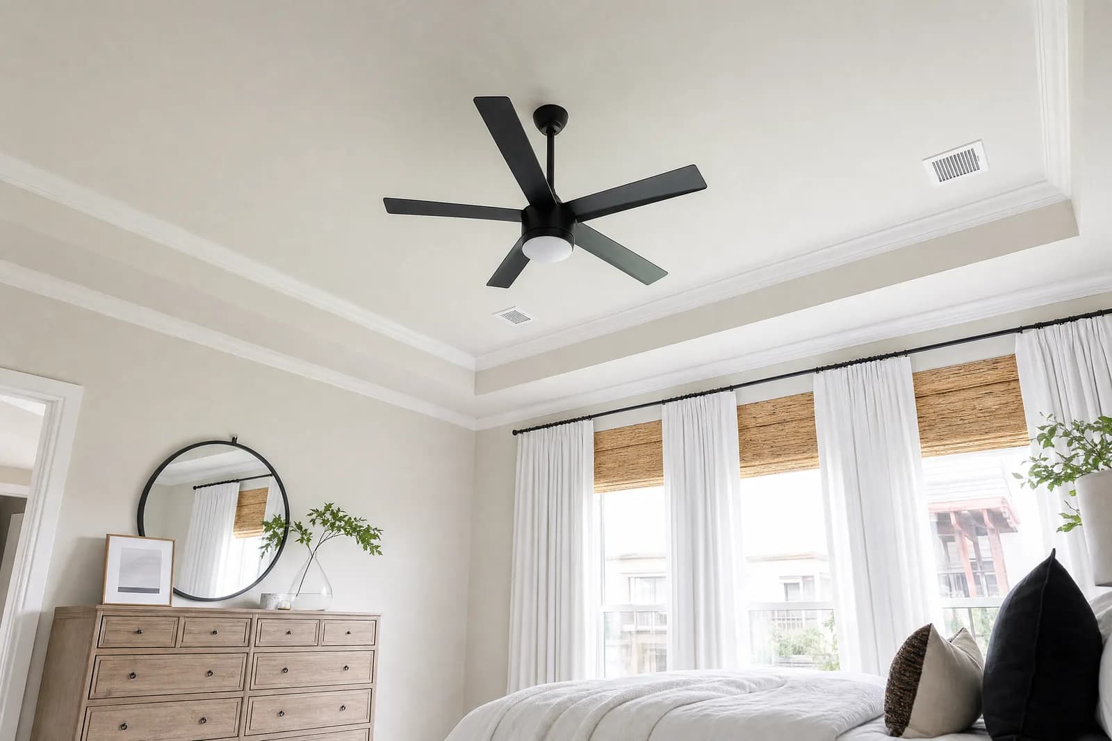 Ceiling fan installed in a bedroom with a tray ceiling by Orthodox Electric