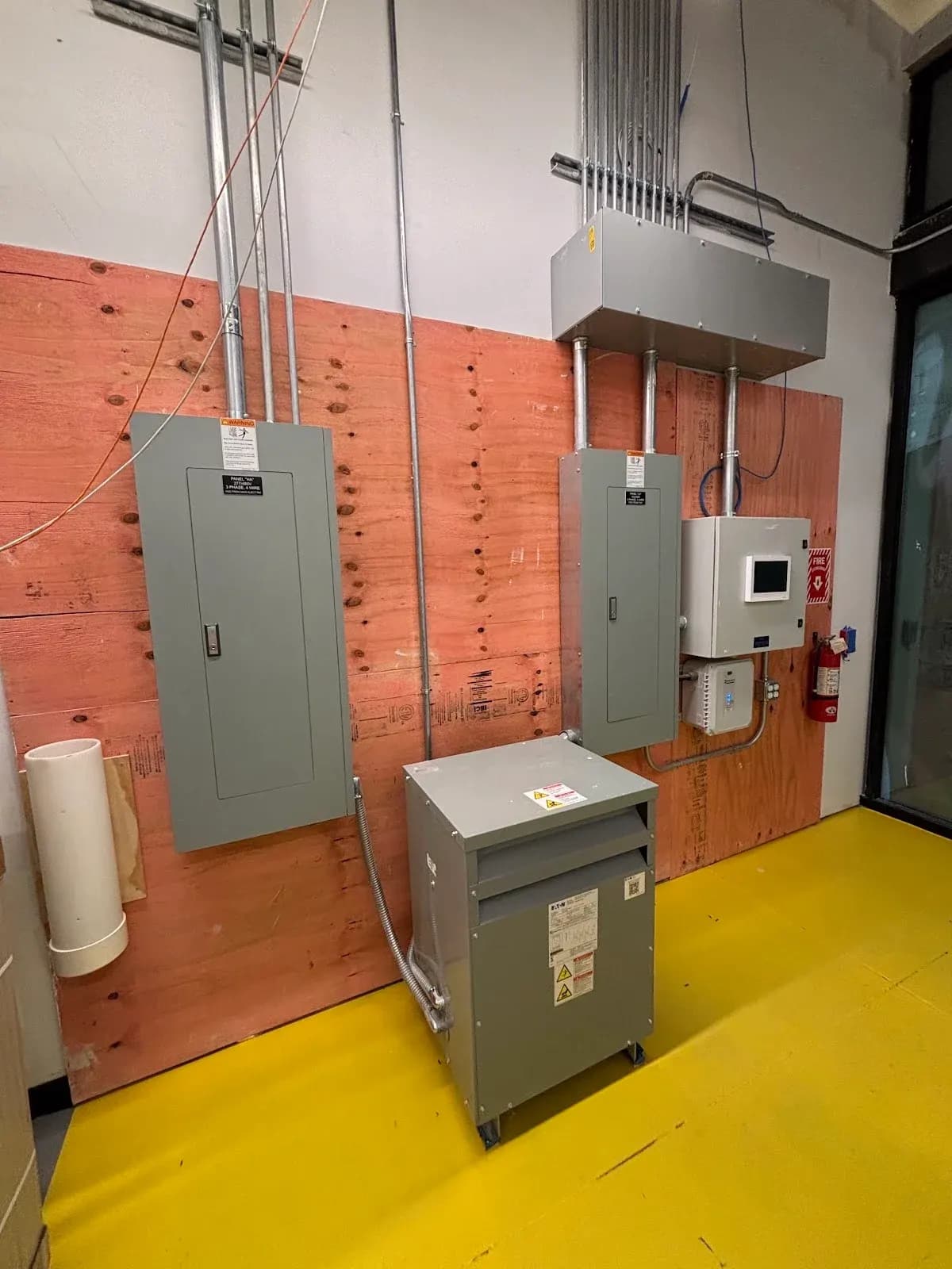 Commercial electrical installation — panels, transformer, and conduit