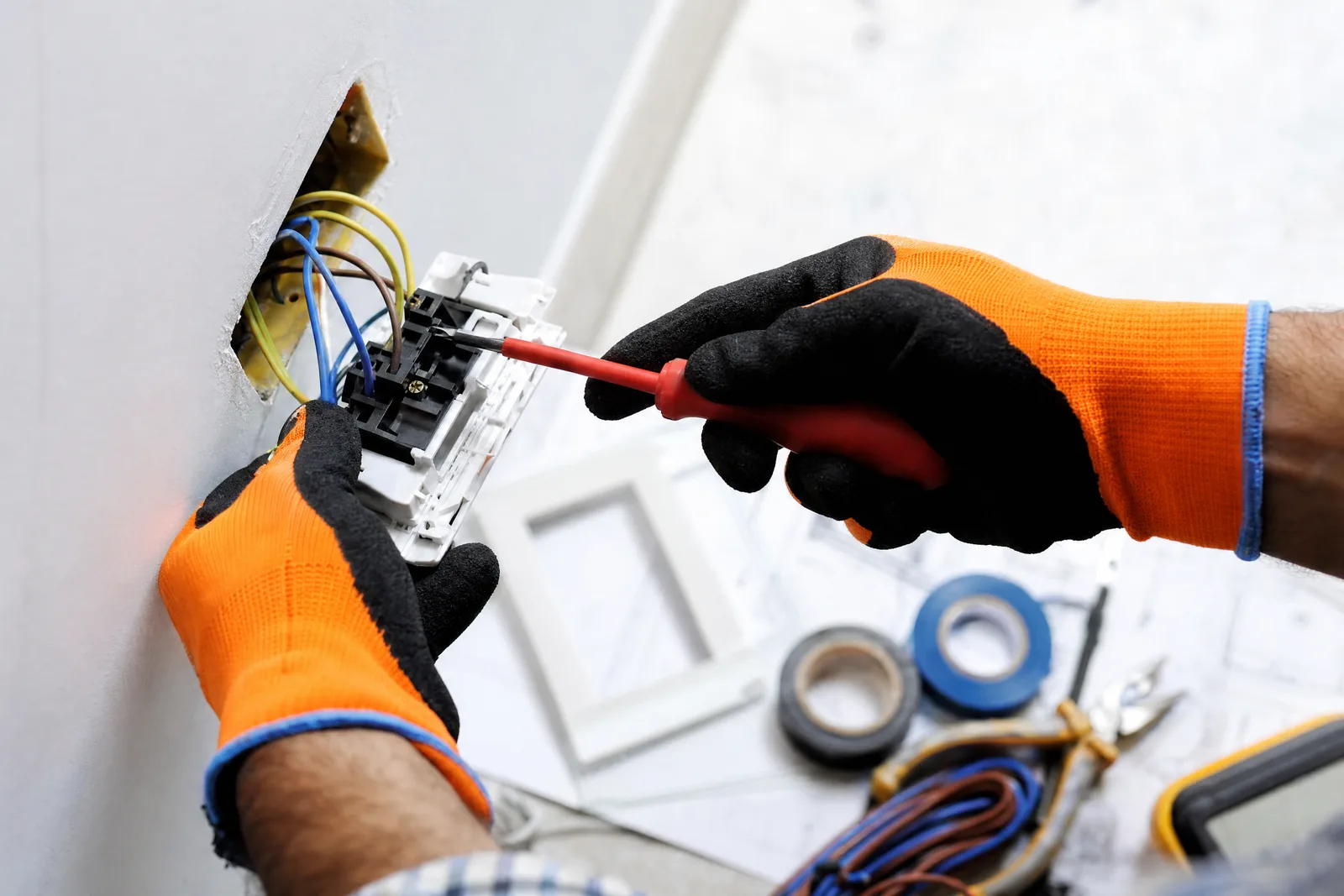 Orthodox Electric electrician wiring a residential light switch